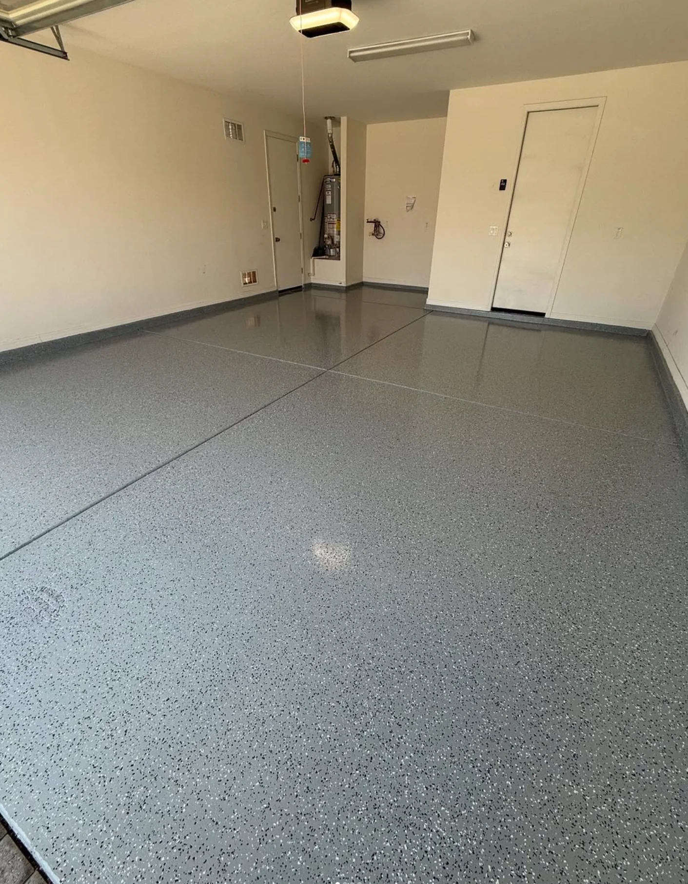 Glossy gray flake epoxy floor in a compact residential garage