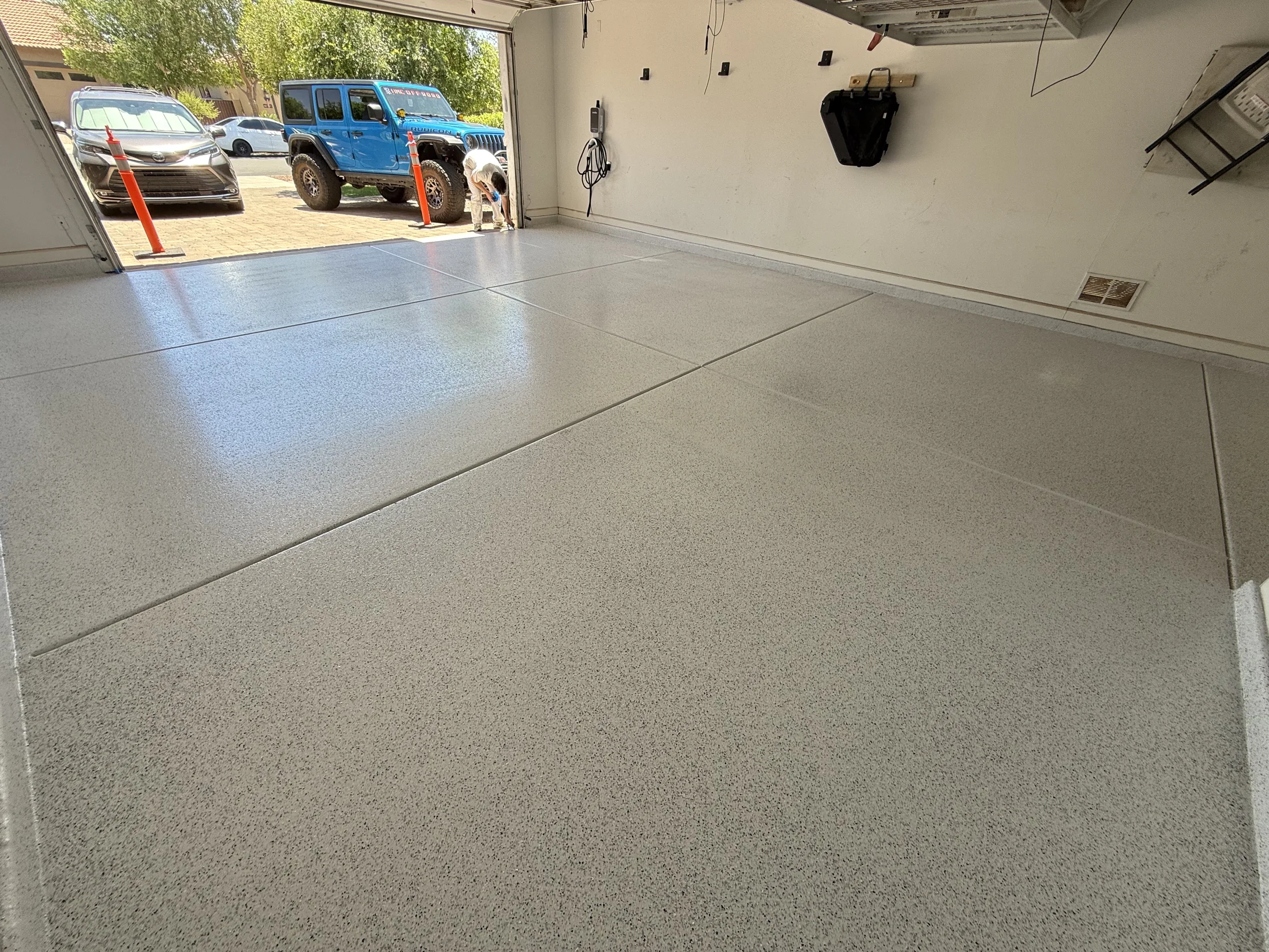 Bright light gray flake epoxy floor in an open two-car garage