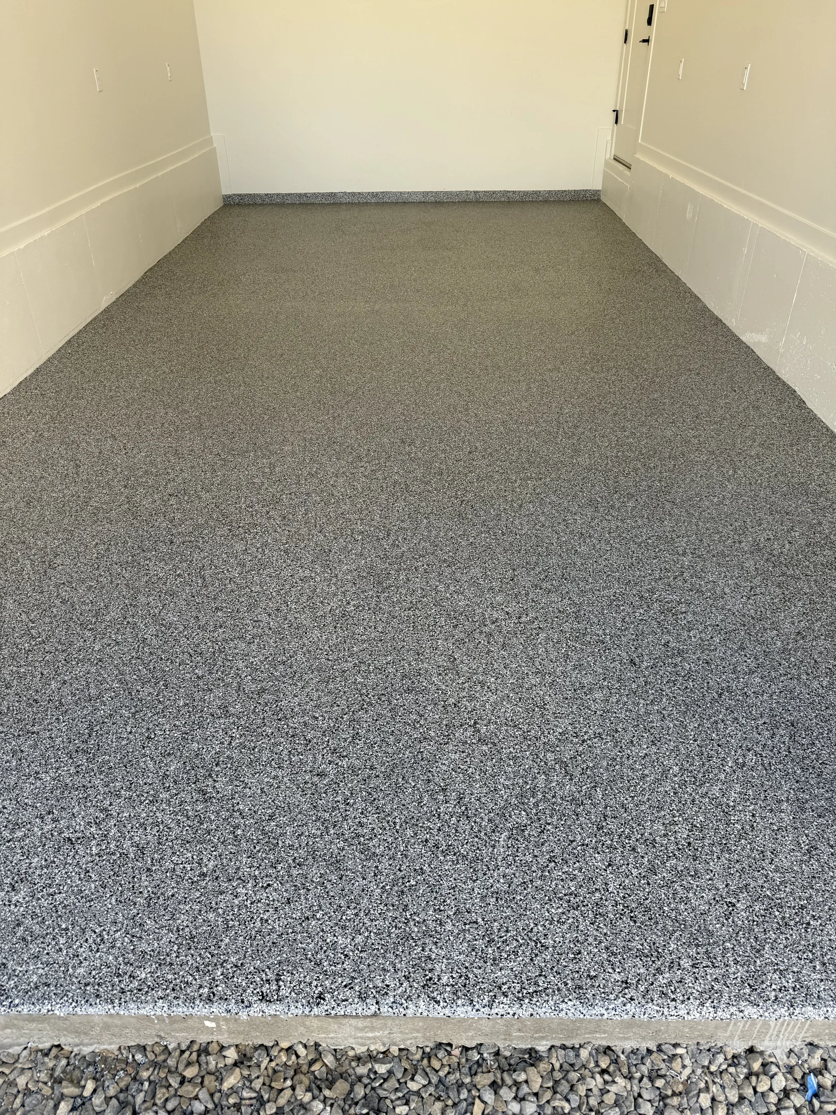 Gray flake epoxy garage floor with a mountain and pool view