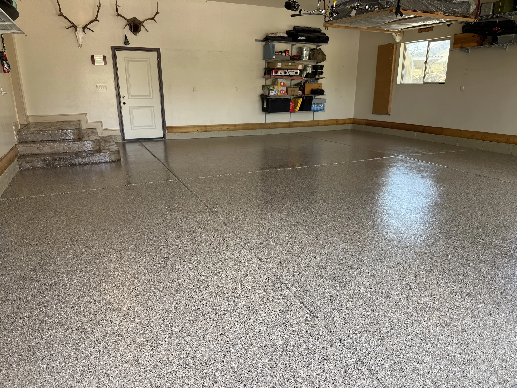 Warm gray flake epoxy floor in a finished residential garage