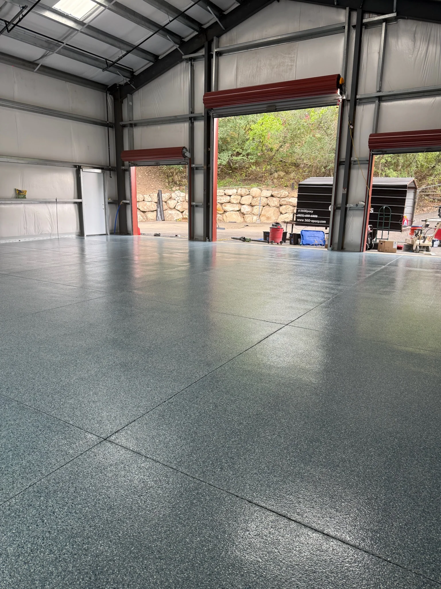 Finished gray epoxy floor in a large commercial workshop
